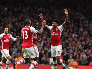 Arsenal Players Celebrating During A Match Against Liverpool.