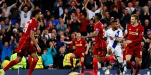 Liverpool players celebrate a goal against Brighton in League Cup.