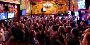 Crowd celebrating in a lively sports bar.